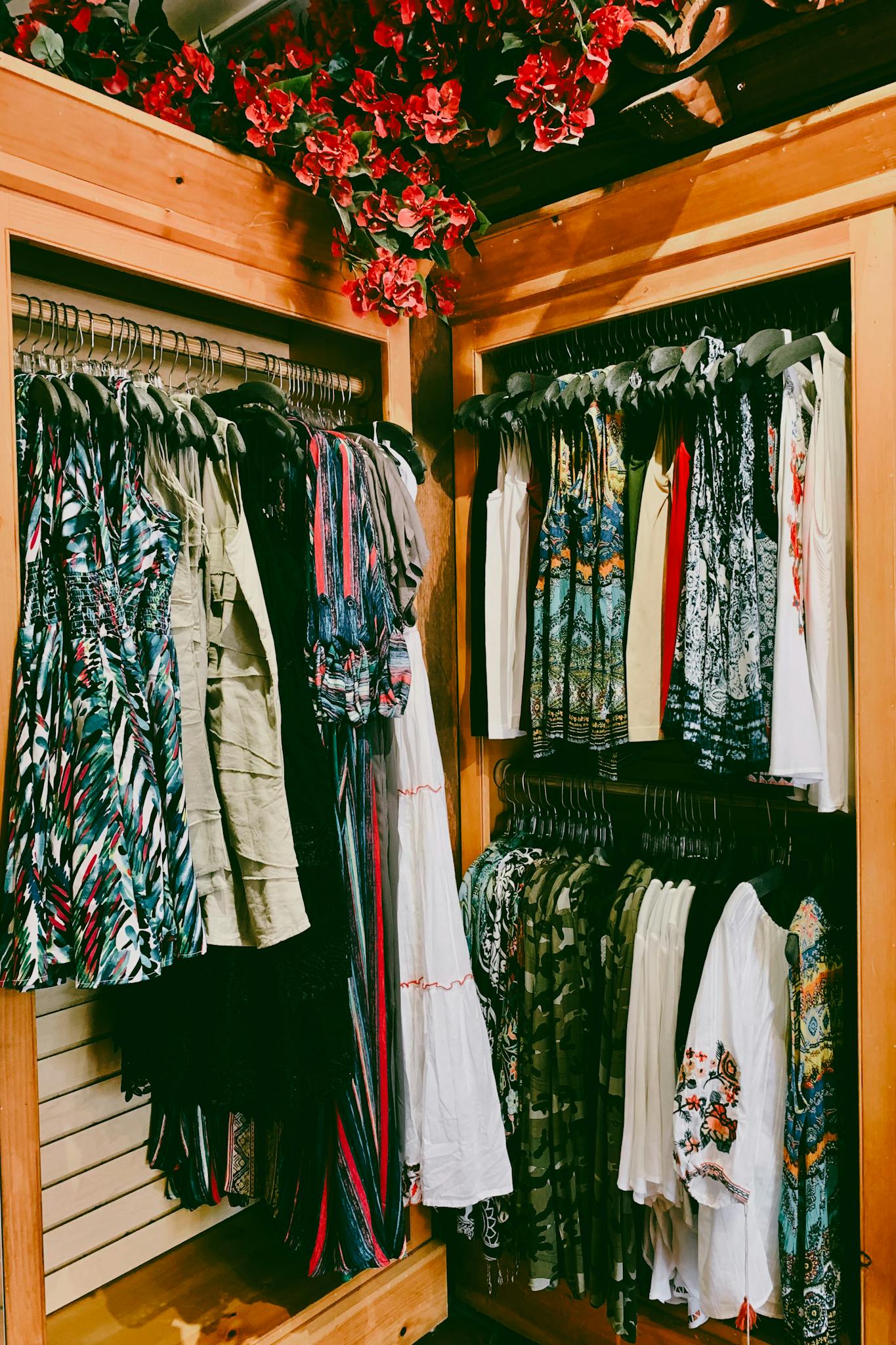 Vibrant collection of women's dresses on hangers in a stylish boutique.